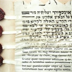 Part of a contract produced in 1931 in the medieval style to record the temporary loan of two Torah scrolls to the Oxford congregation when the Canterbury synagogue closed
