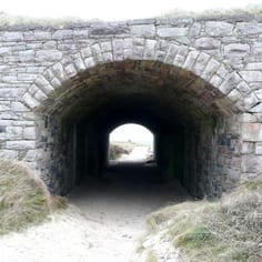 The infamous tunnel to the beach on Arch Bay survives, where the inmates were forced to rehearse their deaths on two occasions in the case of an Allied invasion.