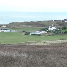 The site and remains of Norderney Camp today (part of the original kitchen block, latrines, hut bases and the Commandant's house remains, with many other remains just below the surface, now in use as a recreational camp site.