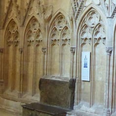South Choir Aisle - The Shrine of Little Hugh and the Lincoln Blood Libel  (map, no. 11) - The remains of the Shrine of Little Hugh with new interpretation panel to the right.  Only the plinth and part of the back survive.The evidence of the shrine's construction suggests that Edward I, the persecutor of Jews, enlarged and repurposed the shrine as propaganda for his own piety and  magnification.