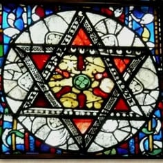 Dean's Eye Window - Scenes of St Hugh of Avalon Burial and 'Jewish' Stars (map, no. 3) - Stars of David in the Cathedral--these may refer to the Psalms of David.