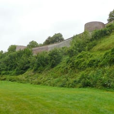 The Glacis and the over-grown entrances to the German tunnels constructed by slave labour, at the foot of the defences at Montreuil.