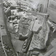 The cement factory at Dannes.  The chalk quarry can be seen to the mid-right of the picture (see shadow of chalk face).  Sick prisoners were worked to death in this pit.