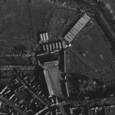 The SS Baubrigade V Camp on the north side of Hesdin.  The rows of c. 10 huts can clearly been seen at the former Napoleonic Cavalry Barracks, La FrezeliÃ¨re.