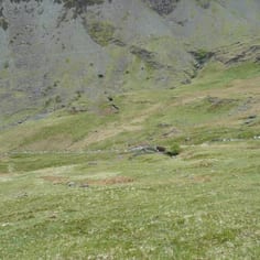 The holes in the steep mountain side beyond the excavated Copper vein represent early prospecting.  Ian Tyler found picks used by the early German miners in the remote shafts.